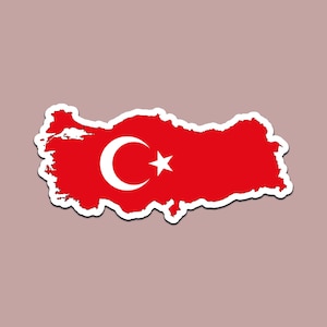 May include: A red sticker in the shape of Turkey, featuring the Turkish flag's crescent moon and star emblem. The sticker has a white border and is set against a neutral background.