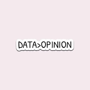 May include: A white sticker with the text "DATA > OPINION" in a black, handwritten-style font. The sticker has a wavy border and is set against a light pink background.