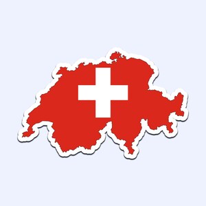May include: A red sticker in the shape of Switzerland, with a white cross in the center. The sticker has a white border and is set against a light blue background. The design represents the Swiss flag.