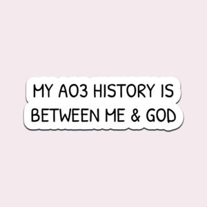 May include: A white sticker with black text that reads "MY AO3 HISTORY IS BETWEEN ME & GOD". The sticker has a rounded rectangular shape and a black border. The background is a light pink color.