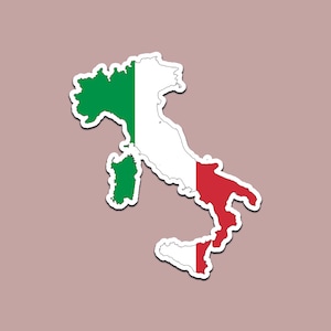 May include: A sticker in the shape of Italy, with the Italian flag colors: green, white, and red. The sticker has a white border and is set against a muted pink background.