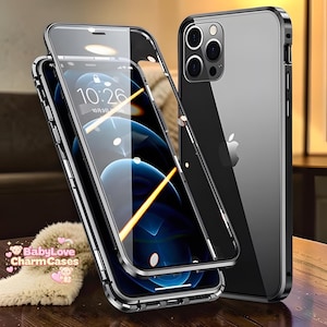 May include: A smartphone with a black metal frame and a clear back panel, featuring a separate magnetic front frame piece. The screen displays a digital clock reading 10:26. A small logo with the text BabyLove CharmCases is visible in the corner.