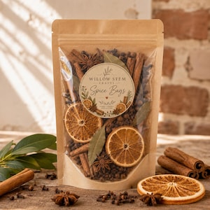 May include: A clear and brown paper pouch filled with dried spices including cinnamon sticks, star anise, whole cloves, bay leaves, and dried orange slices. A circular label reads Willow Stem Crafts Spice Bags.
