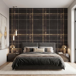 May include: A bedroom featuring a dark brown and gold plaid wallpaper behind a gray upholstered bed. The bed is dressed in dark gray bedding with neutral pillows. Two dark gray nightstands with gold lamps flank the bed, and a large framed abstract painting hangs on the left wall.
