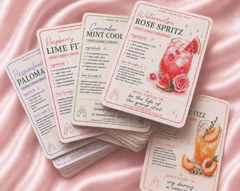 May include: A stack of rectangular recipe cards titled Sober-ish Social Club, featuring illustrations of cocktails like Watermelon Rose Spritz, Cucumber Mint Cool, and Raspberry Lime Fizz. Each card lists ingredients, instructions, and a fun personality prompt.
