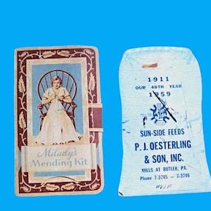 Könnte beinhalten: Eine Vintage-Milady's Mending Kit-Box mit einer Frau, die auf einem Stuhl sitzt und strickt. Die Box hat ein rot-weiß-blaues Design mit dem Text "Milady's Mending Kit". Die Rückseite der Box zeigt ein blaues und weißes Etikett mit dem Text "Sun-Side Feeds P.J. Oesterling & Son, Inc. Mills at Butler, PA Phone 7-3745 - 7-3746 PVIF".