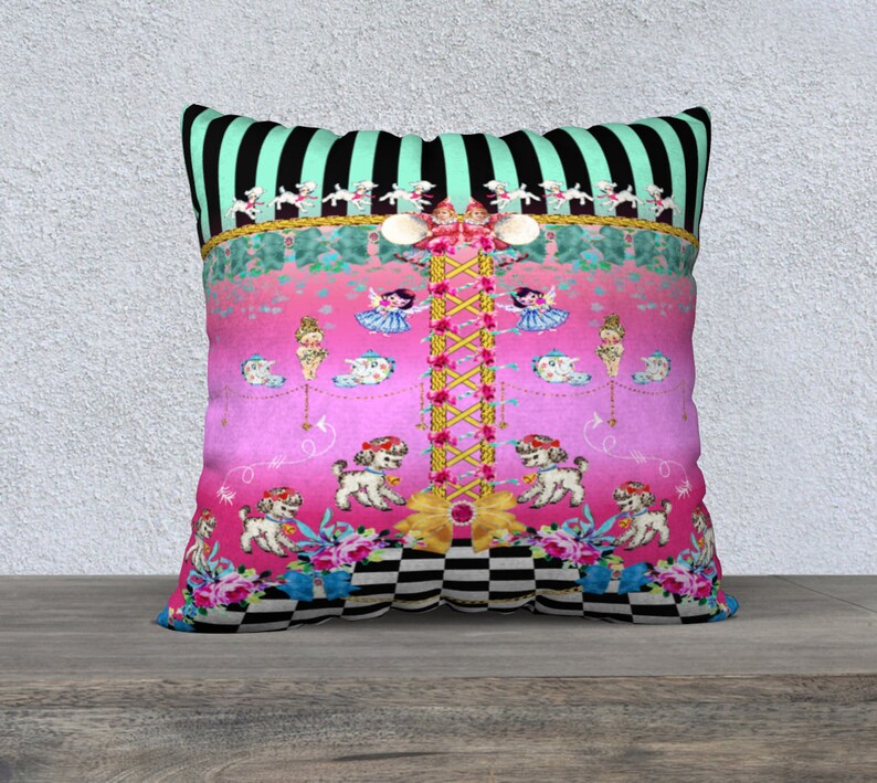 May include: A pink and green decorative pillow with a black and white checkered pattern at the bottom. The pillow features a whimsical design with a central column of flowers and a series of small dolls and dogs.