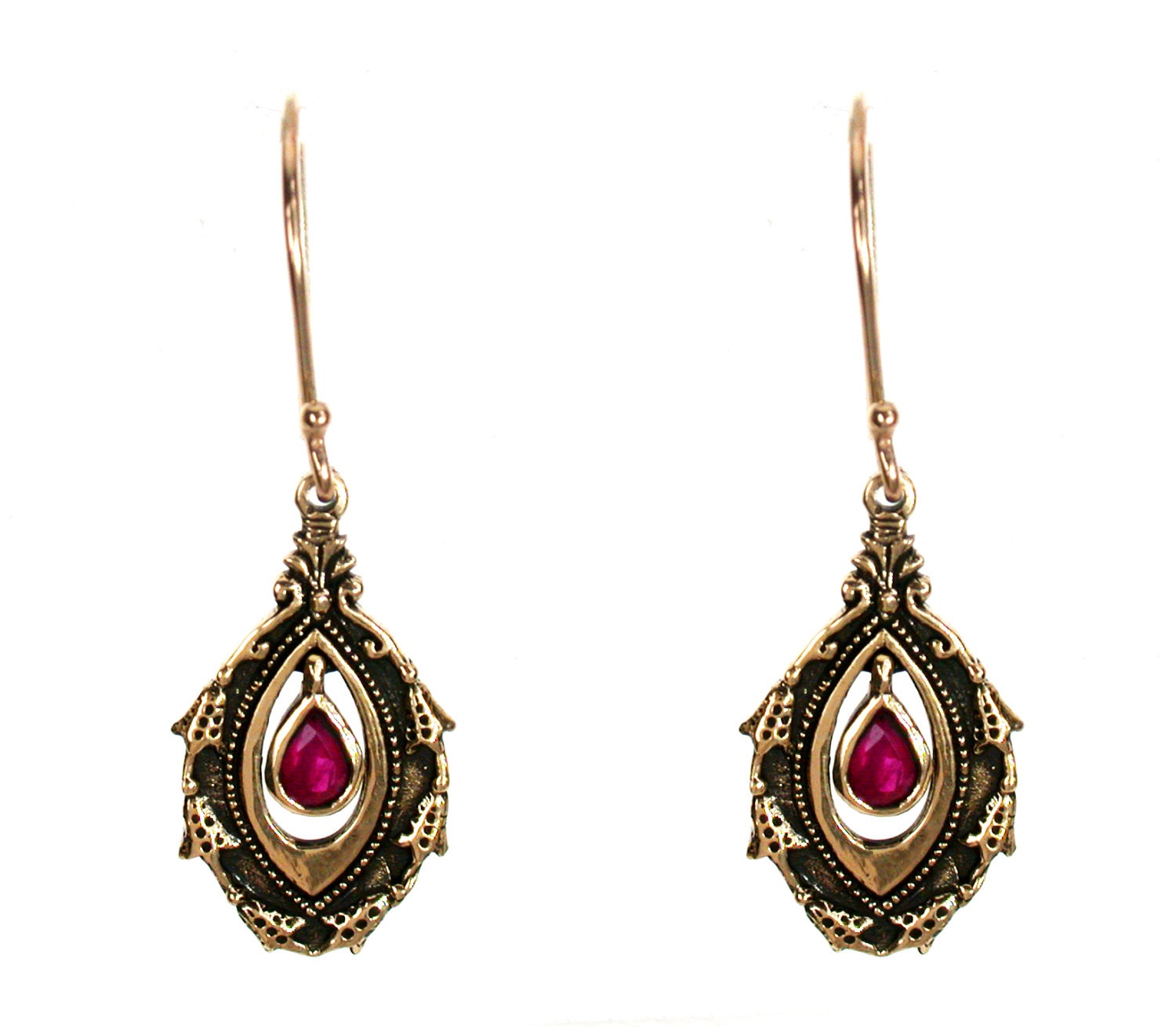 Lot - A PAIR OF VINTAGE 18CT GOLD SYNTHETIC RUBY EARRINGS;each collet set  with a round cut synthetic ruby to knot surround on continental...