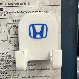 May include: A white ceramic mug with a black handle and the text "But First, Coffee" in a black, bold font. The mug is on a white surface.