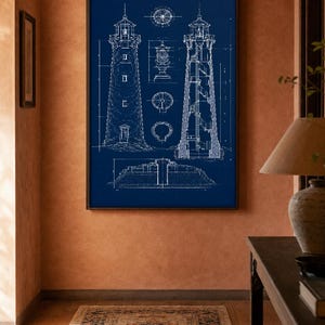 May include: A framed wall art print featuring a white technical blueprint of a lighthouse on a deep blue background. The illustration displays the exterior view, a cross-section showing internal stairs, and detailed architectural floor plans.