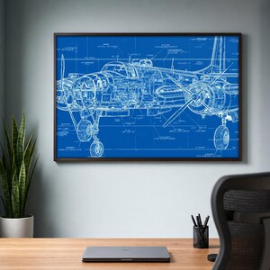 May include: A framed wall art print featuring a detailed white technical blueprint of a vintage airplane on a solid blue background. The illustration displays the aircraft's structural components, landing gear, and propellers in fine line work.
