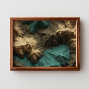 May include: A framed abstract art print featuring a topographic design. The artwork showcases a layered effect with shades of brown, teal, and dark green, creating a three-dimensional appearance. The wooden frame adds a classic touch to the piece.
