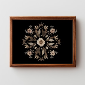 May include: A framed floral print featuring a symmetrical arrangement of beige and brown flowers and leaves against a black background. The wooden frame adds a natural touch to the artwork, creating a balanced and elegant composition.