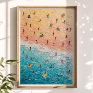 May include: A textured oil painting in a wooden frame depicting an aerial view of a beach scene. The composition features a sandy shore in shades of yellow and pink, transitioning into turquoise ocean water with people swimming and surfing.