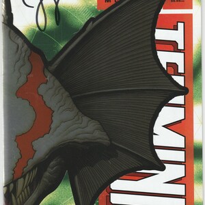 May include: A comic book titled Terminal issue number 1, featuring a black signature on the cover. The artwork displays a large, dark, winged creature with sharp teeth against a green background with a grid pattern and a vertical red banner.