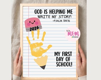 May include: A framed print on lined paper featuring a yellow handprint as a pencil body, with a pink eraser top labeled 2026. Text reads: GOD IS HELPING ME WRITE MY STORY! -PSALM 139:16 and MY FIRST DAY OF SCHOOL! A circular logo says DIY MOM IDEAS.