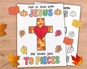 May include: A white paper craft sheet featuring the text Fall in love with JESUS He loves you TO PIECES. The design includes a central cross filled with orange, yellow, and brown paper pieces, a red heart, pumpkins, and various autumn leaves.
