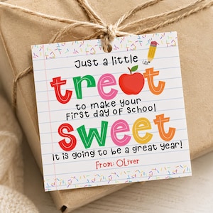 May include: A square gift tag with a white background featuring lined paper patterns and colorful sprinkles. The text reads: Just a little treat to make your First day of School SWEET. It is going to be a great year! From: Oliver. Includes a red apple and pencil icon.