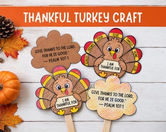 May include: A Thankful Turkey craft set featuring two paper turkey cutouts with colorful feathers labeled with words like food, toys, and family, and two cloud-shaped paper signs printed with the text Give thanks to the Lord, for he is good. Psalm 107:1.