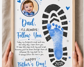 May include: A framed print featuring a circular photo of a baby, a large black boot print, and a blue baby footprint. The text reads: Dad, I'll always follow you, a poem, Happy Father's Day, and Love: Caleb. The design includes blue hearts and stars.