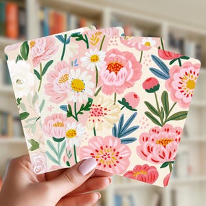 May include: A set of rectangular cards featuring a repeating pattern of painted flowers in shades of pink, white, and yellow with green foliage. The floral illustrations include peonies, daisies, and small buds on a light cream-colored background.