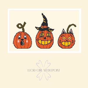 May include: A pixel art cross stitch pattern featuring three orange pumpkins on a cream background. The first pumpkin has a surprised expression, the second wears a black witch hat, and the third has cat ears. Text reads LUCKY GIRL NEEDLEPOINT.