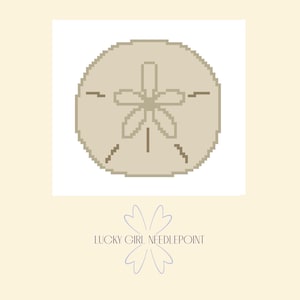 May include: A pixelated sand dollar design in shades of tan and beige, centered on a white square. Below, the text "LUCKY GIRL NEEDLEPOINT" is displayed with a floral graphic.