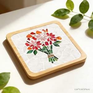 May include: Square mosaic coaster with a bamboo frame. The mosaic features a bouquet of red, pink, and orange flowers with green leaves and stems. The coaster measures 3.54" x 3.54" (9x9cm).