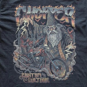 Close-up of a dark graphic tee design with a detailed wizard biker artwork, lightning effects, skulls, and bold “Chopper” typography in a fiery vintage metal-inspired style.