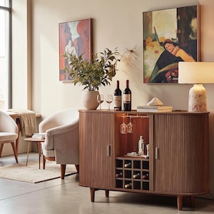 May include: A walnut-toned wooden sideboard featuring a central open compartment with a wine rack, two glass stemware holders, and two side cabinets with vertical slatted doors. The unit stands on four tapered legs and includes metal handles.