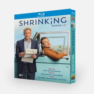 May include: Blu-ray disc box set for the TV series "Shrinking: Season 3". The box is teal and features two actors in front of a teal car. The title "Shrinking" is in large white letters. The box also lists the director, writers, and stars.