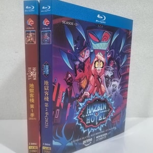May include: A Blu-ray box set for "Hazbin Hotel" seasons 1 and 2. The box set features colourful artwork of characters from the animated series. The spines are red and purple with Japanese text. The box set includes the text "New Season October 29".