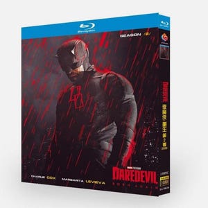 May include: Blu-ray disc of the television series "Daredevil: Born Again" Season 2. The cover shows a dark image of the character in a red and black costume, with the title and cast names at the bottom. The disc is in a blue case.