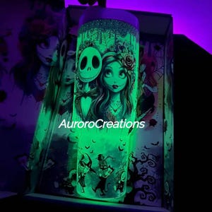 May include: A glowing green tumbler featuring Jack Skellington and Sally from The Nightmare Before Christmas. The tumbler has a glittery top and a wraparound design with the text "AuroroCreations". The design includes bats and other spooky elements.