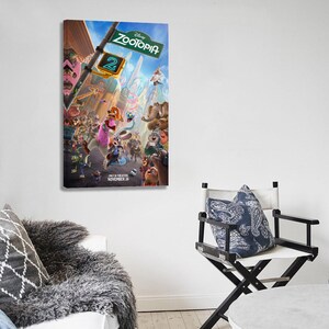 May include: A framed canvas print of the Disney movie "Zootopia 2" poster. The poster features a vibrant scene with numerous animated animal characters in a city setting. The sign reads "Zootopia" and "2". The release date is November 26.