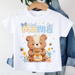 May include: A white ceramic mug with a black handle and the text "But First, Coffee" in a bold, black font. The mug is set against a blurred background, suggesting a cozy setting.