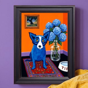 May include: Framed artwork featuring a blue dog with yellow eyes sitting on a red rug. A vase of blue hydrangeas and a small painting hang on the orange wall. A dog bowl with the word "Tiff" is on the floor.