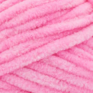 May include: Close-up of a skein of soft, pink yarn. The yarn has a thick, plush texture with visible strands and a slightly fuzzy appearance. The colour is a vibrant, light pink, ideal for knitting or crocheting projects.