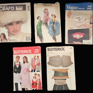 May include: Five vintage sewing patterns for crafts. The patterns include a fur hat, a shawl, a dress, a vest and an apron. The patterns are from McCall's, Vogue and Butterick.