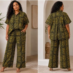 May include: A two-piece set consisting of a short-sleeved button-down shirt and wide-leg trousers. Both pieces feature a repeating black and yellow geometric pattern. The shirt has a classic collar, and the trousers have a relaxed, straight-leg fit.