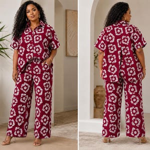 May include: A two-piece set consisting of a short-sleeved button-down shirt and wide-leg trousers. The garment features a deep burgundy base color with a repeating white geometric pattern of interconnected shapes and lines throughout the fabric.