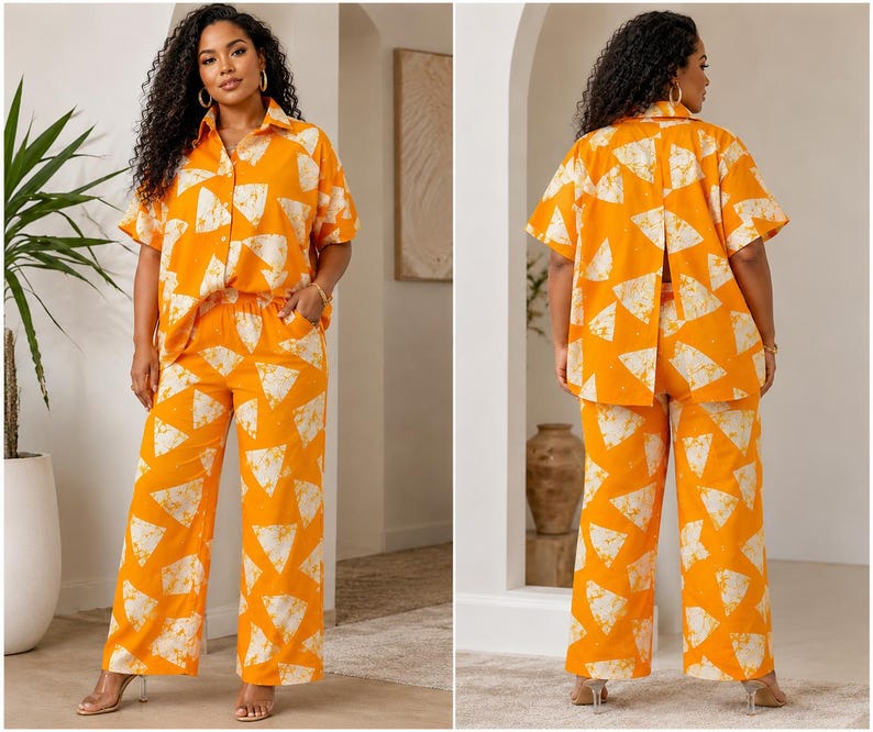 May include: A two-piece set consisting of a short-sleeved button-down shirt with a collar and wide-leg trousers. Both pieces feature a vibrant orange base color with a repeating white triangular pattern. The shirt has a split back design.