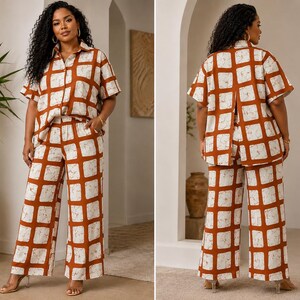 May include: A two-piece set consisting of a short-sleeved button-down shirt and wide-leg trousers. Both pieces feature a bold, rust-orange grid pattern over a cream-colored base with a subtle, marbled texture throughout the fabric design.