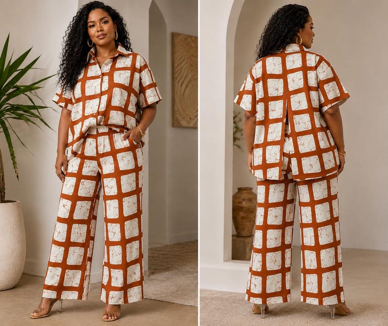 May include: A two-piece set consisting of a short-sleeved button-down shirt and wide-leg trousers. Both pieces feature a bold, rust-orange grid pattern over a cream-colored base with a subtle, marbled texture throughout the fabric design.