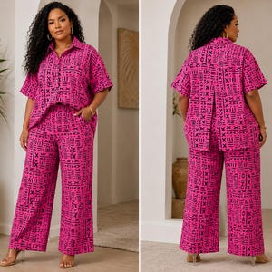 May include: A two-piece set consisting of a short-sleeved button-down shirt with a collar and wide-leg trousers. Both pieces feature a vibrant hot pink base color with a repeating black geometric pattern of lines, crosses, and abstract shapes.