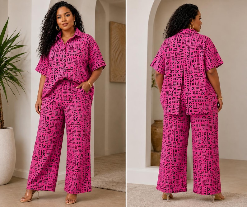 May include: A two-piece set consisting of a short-sleeved button-down shirt with a collar and wide-leg trousers. Both pieces feature a vibrant hot pink base color with a repeating black geometric pattern of lines, crosses, and abstract shapes.