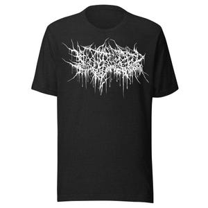 May include: Dark gray t-shirt with a white, stylized, gothic-style text design across the chest. The text appears to be a band name or logo. The shirt has short sleeves and a crew neck.