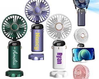 May include: A collection of portable personal fans in various colors, including green, purple, white, blue, and pink. Each fan has a digital display and a name printed on the handle. Some fans are shown with a charging cable and a smartphone.