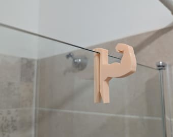 Crochet porte-serviette muscle pour paroi de douche