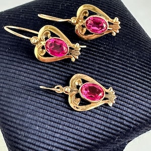 May include: A set of three ceramic mugs with a speckled, matte finish. The mugs are in shades of cream, gray, and black. Each mug has a simple, minimalist design, perfect for coffee or tea. The mugs are stacked on top of each other.